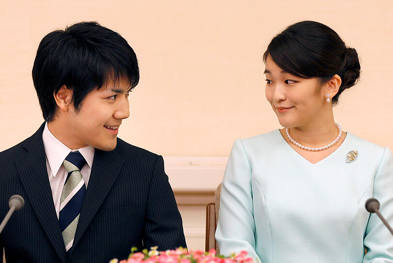 1 Princess Mako, the elder daughter of Prince Akishino and Princess Kiko, and her fiancee Kei Komuro, a university friend of Princess Mako, smile during a press conference to announce their engagement at Akasaka East Residence in Tokyo